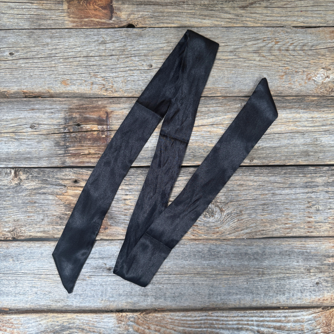 Black tie on a wooden surface