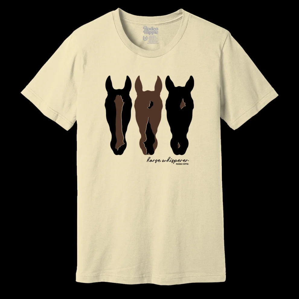 An off-white short-sleeve t-shirt with a graphic of three horse heads in black and brown silhouettes on the front, with the text 'large whiner' and 'MADE IN USA' printed below.