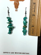 Handcrafted turquoise chip dangle earrings displayed with ruler for size reference.”