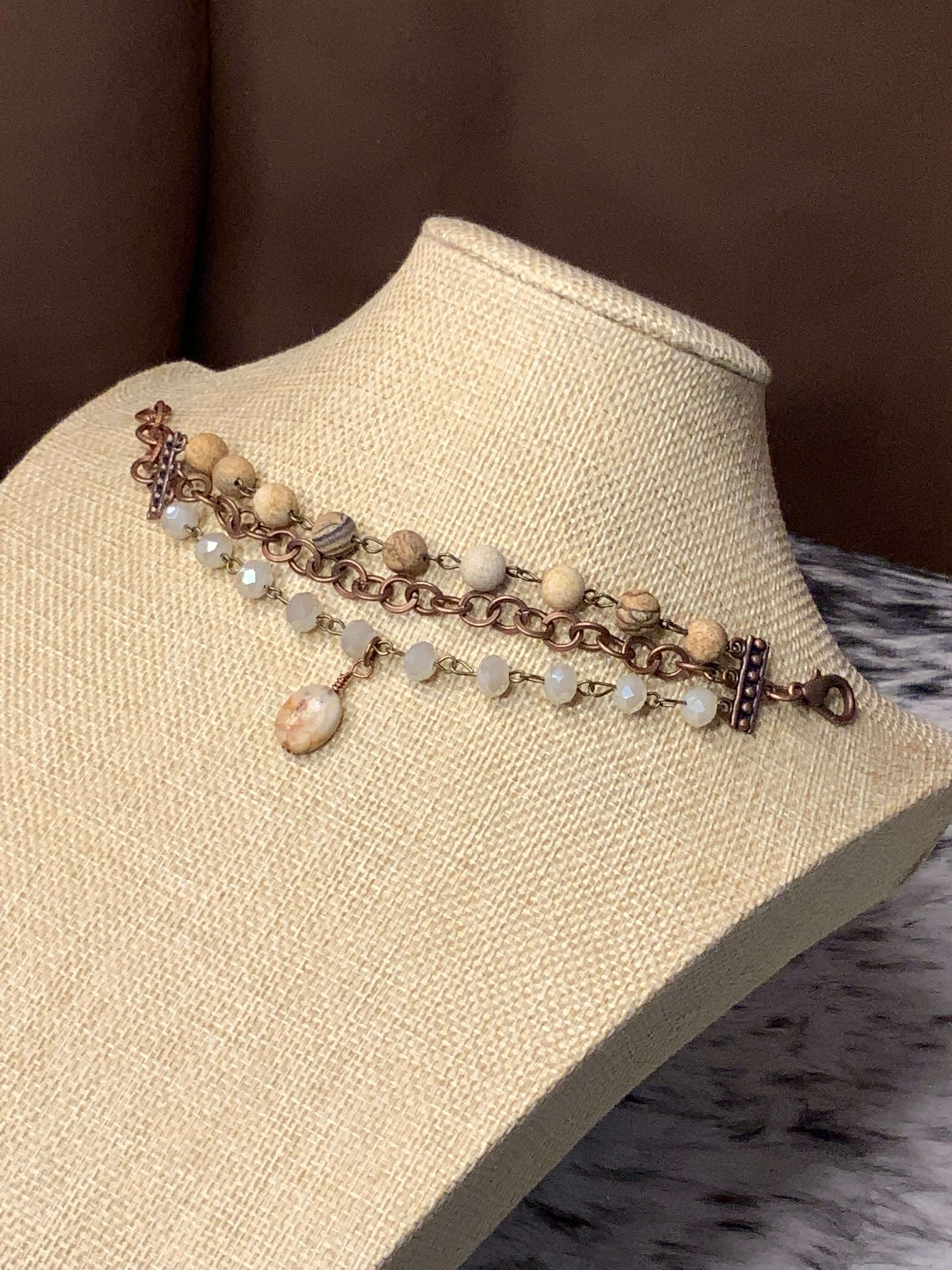 Aurora's Elegance Handcrafted Copper, Ivory Crystals, and Agate Stone Bracelet displayed on a mannequin bust with a neutral background.
