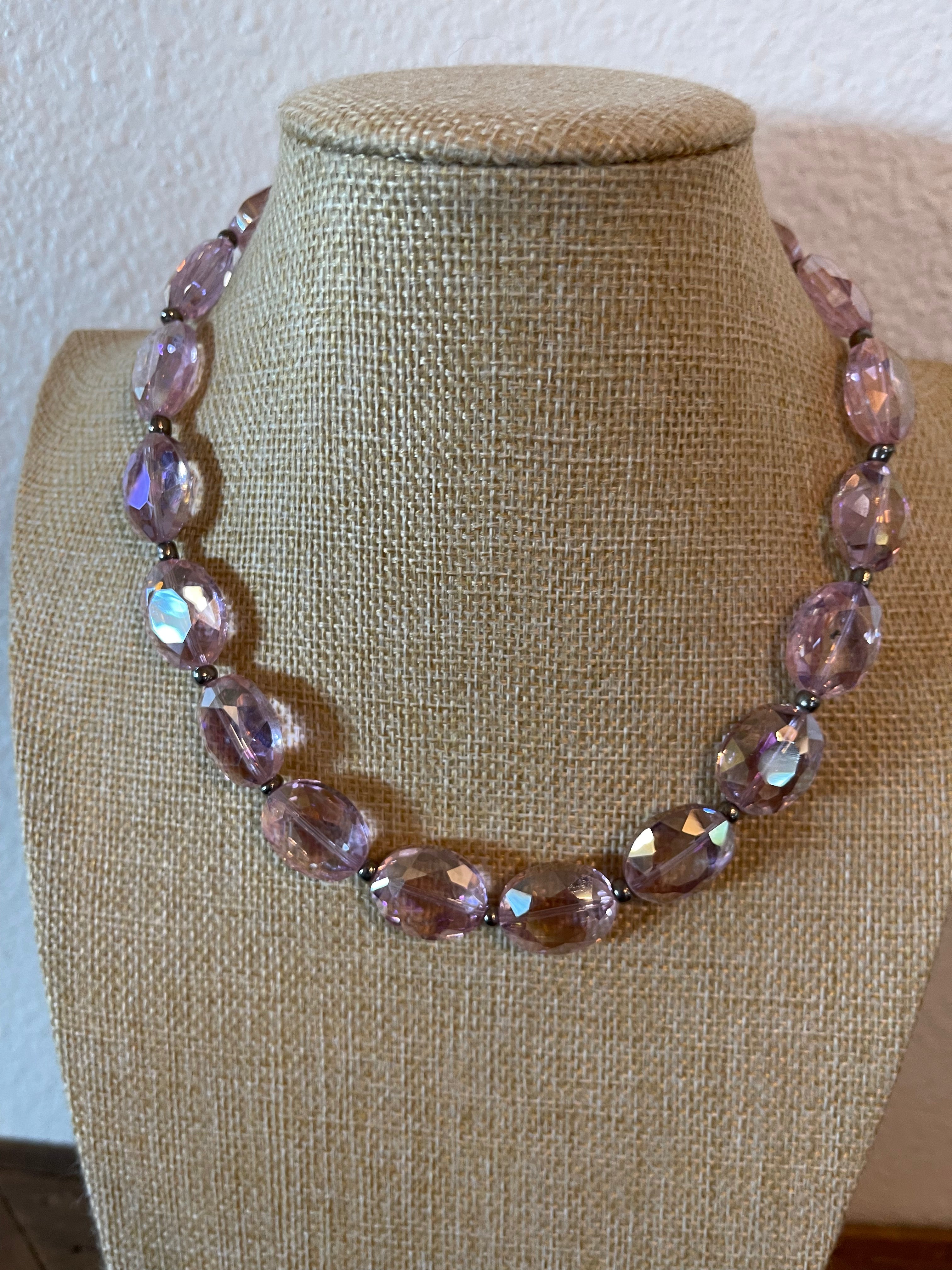 Pink crystal necklace with silver seed beads in between the crystals.
