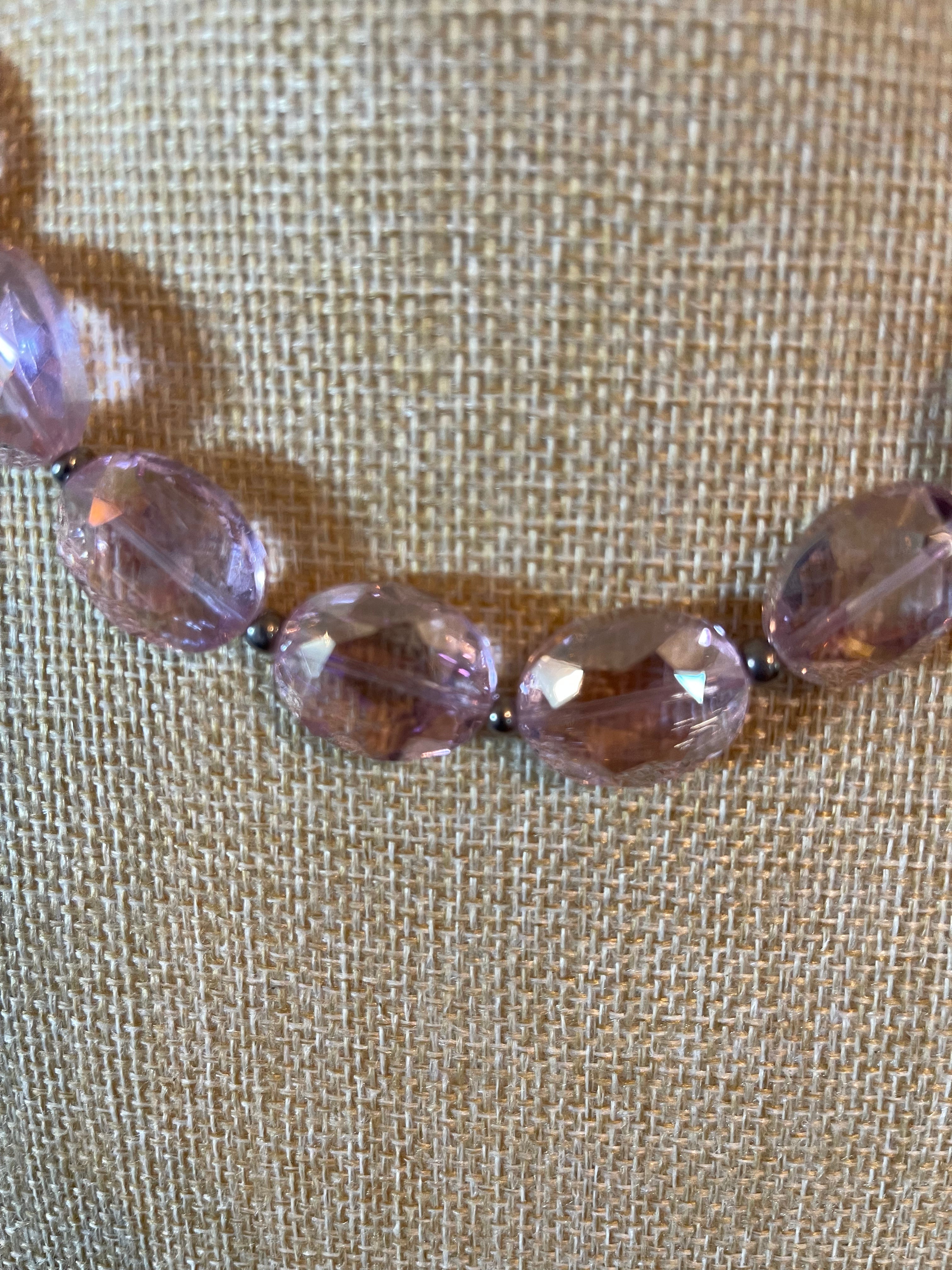 Pink crystal necklace with silver seed beads in between the crystals.