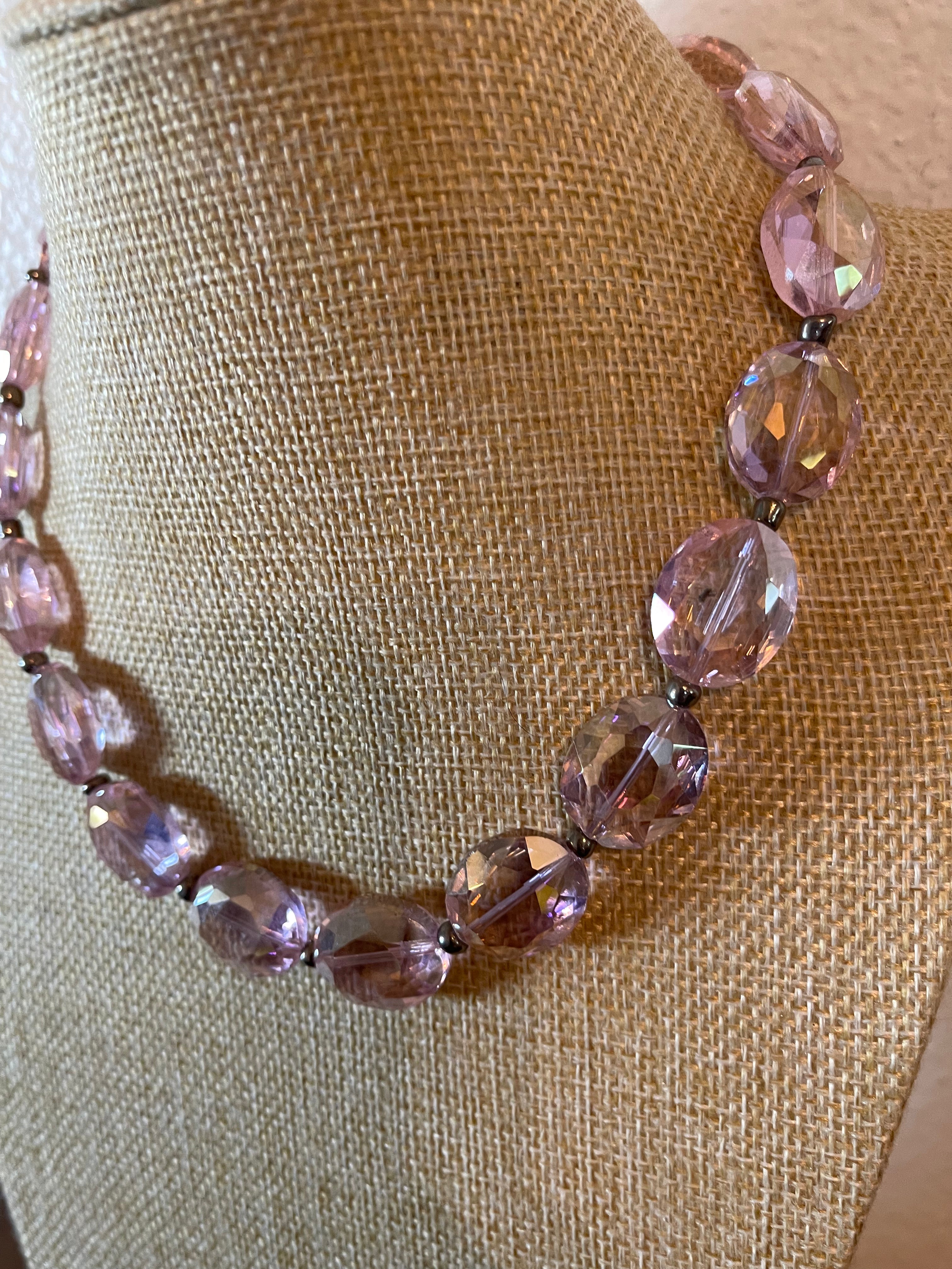 Pink crystal necklace with silver seed beads in between the crystals.
