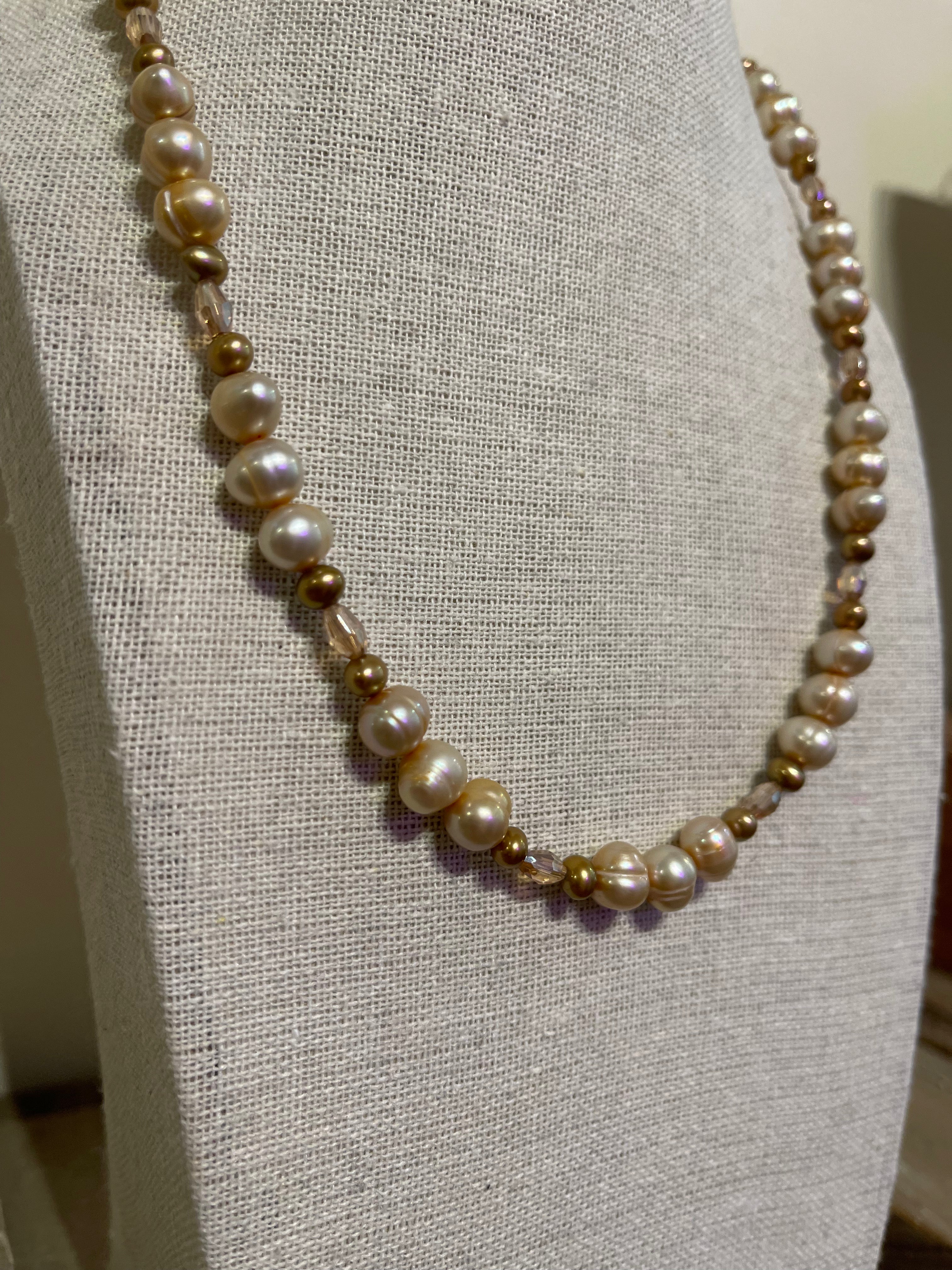 Pearl necklace on a gray mannequin bust