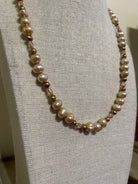Pearl necklace on a gray mannequin bust