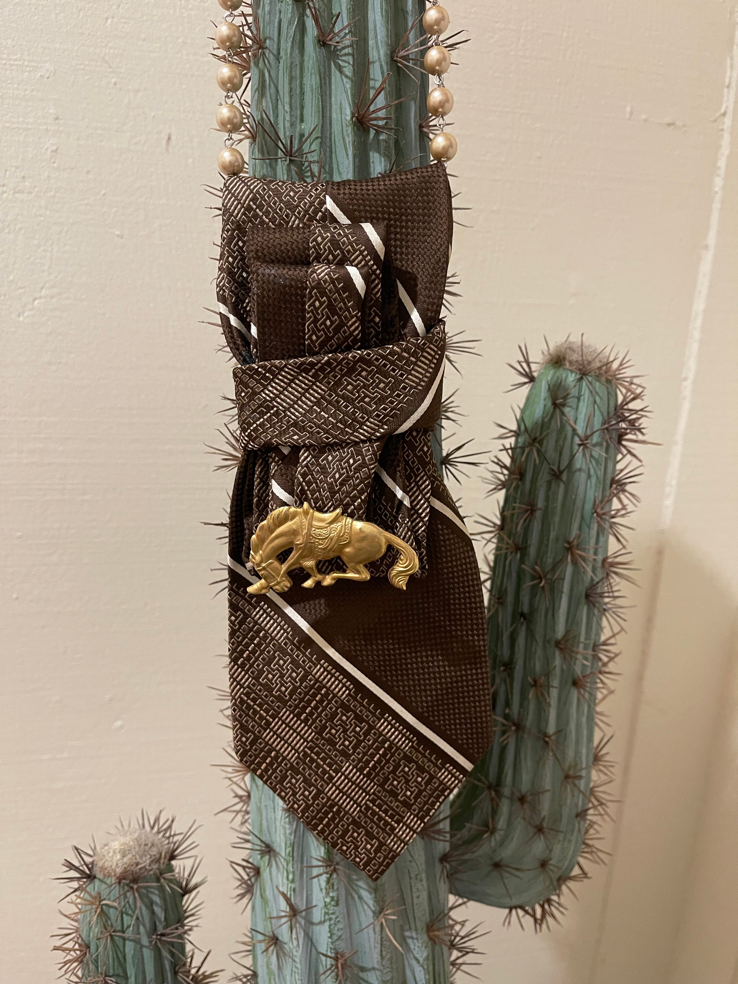 Handcrafted vintage tie necklace by Copper &amp; Lace Western Boutique featuring an authentic 1970s brown patterned necktie, champagne pearl strand, and vintage gold-tone horse brooch.
