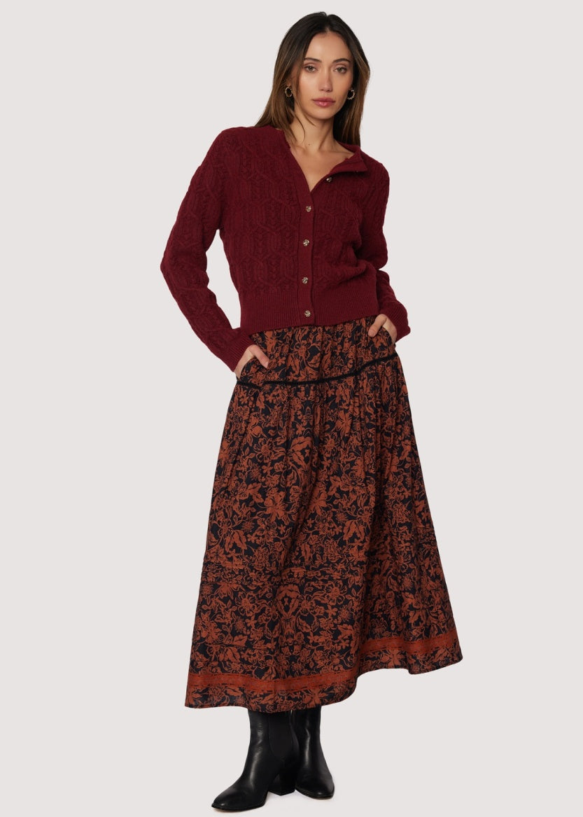 front view long skirt rust floral pattern over black background