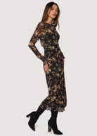Woman wearing a floral dress with long sleeves on a white background