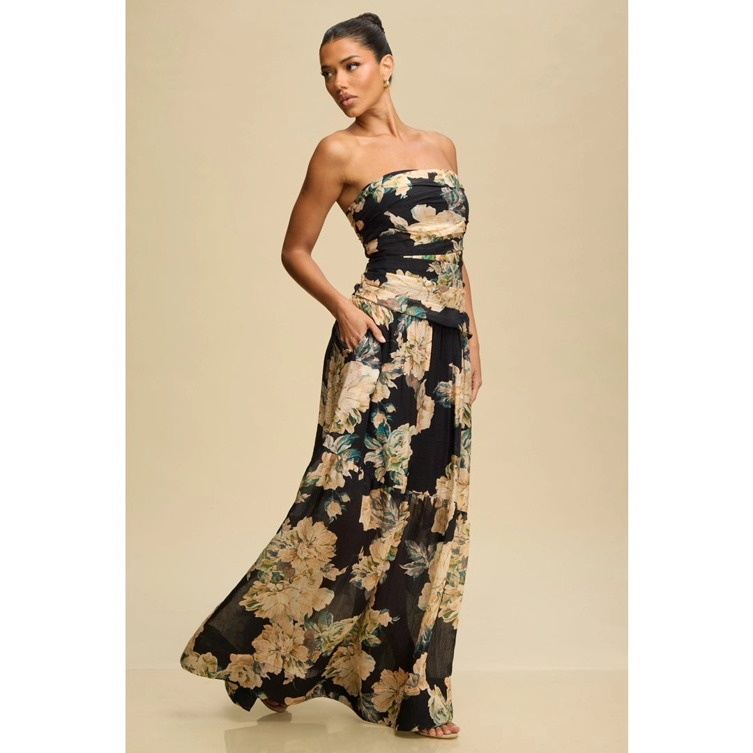 Woman wearing a strapless floral dress against a beige background