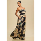 Woman wearing a strapless floral dress against a beige background