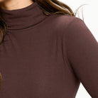 Close-up of a brown ribbed turtleneck sweater