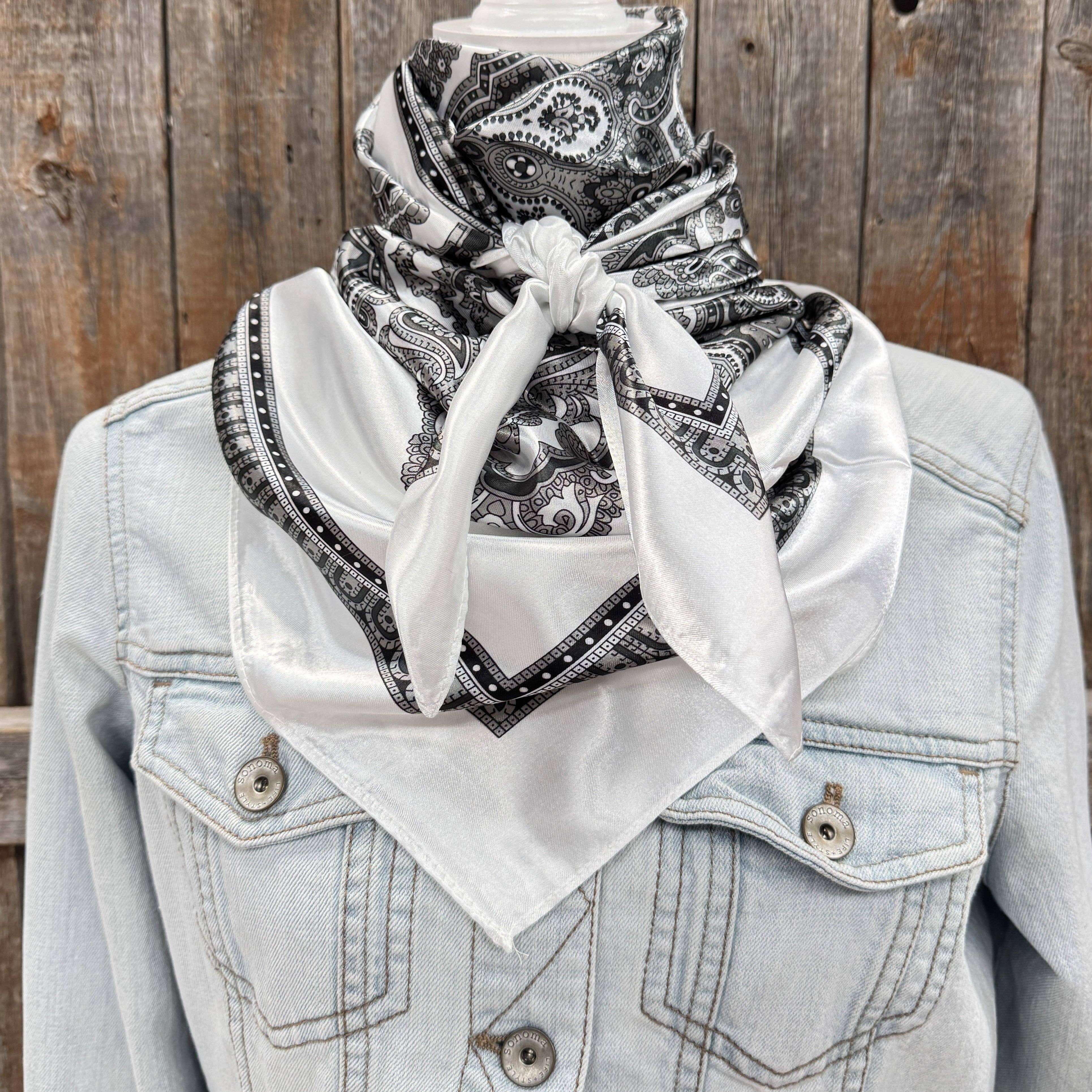 Light blue denim jacket with a white bandana and black paisley pattern against a wooden background