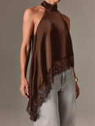 Brown halter top with lace detail worn by a model on a plain background