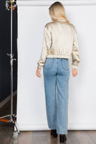 Lightweight satin bomber jacket featuring a relaxed fit, full front zipper, elastic cuffs, fully lined construction, utility sleeve pocket, and side pockets for polished everyday layering.