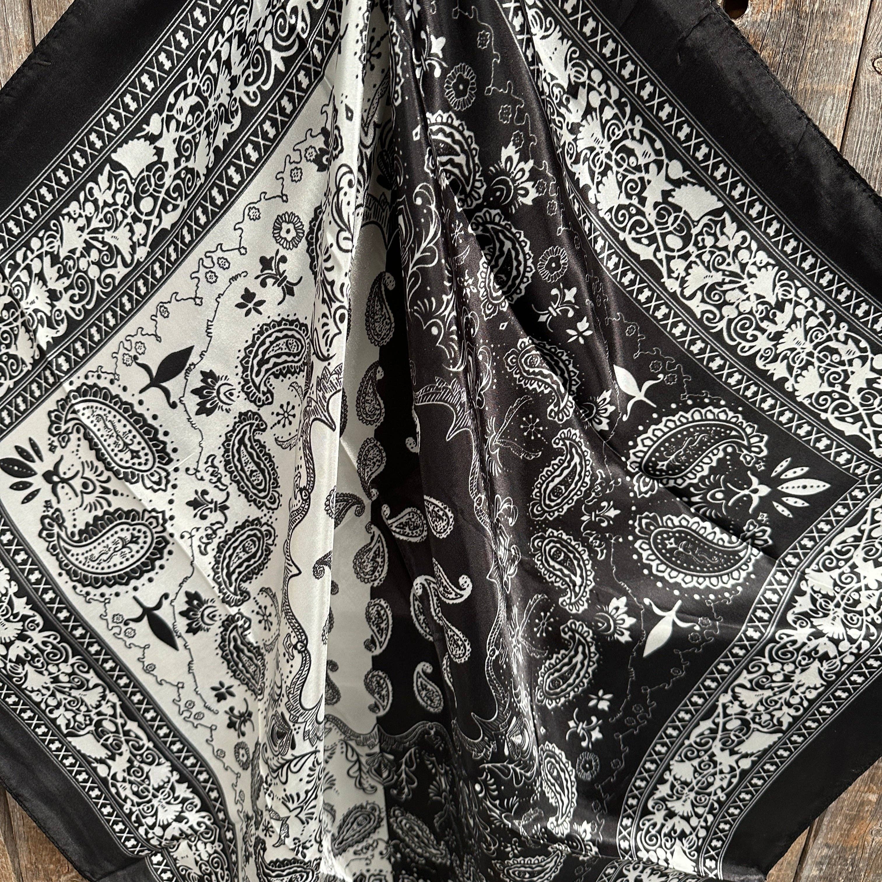 Black and white paisley patterned fabric on a wooden surface