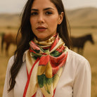 Woman wearing a colorful  floral scarf with a scenic background