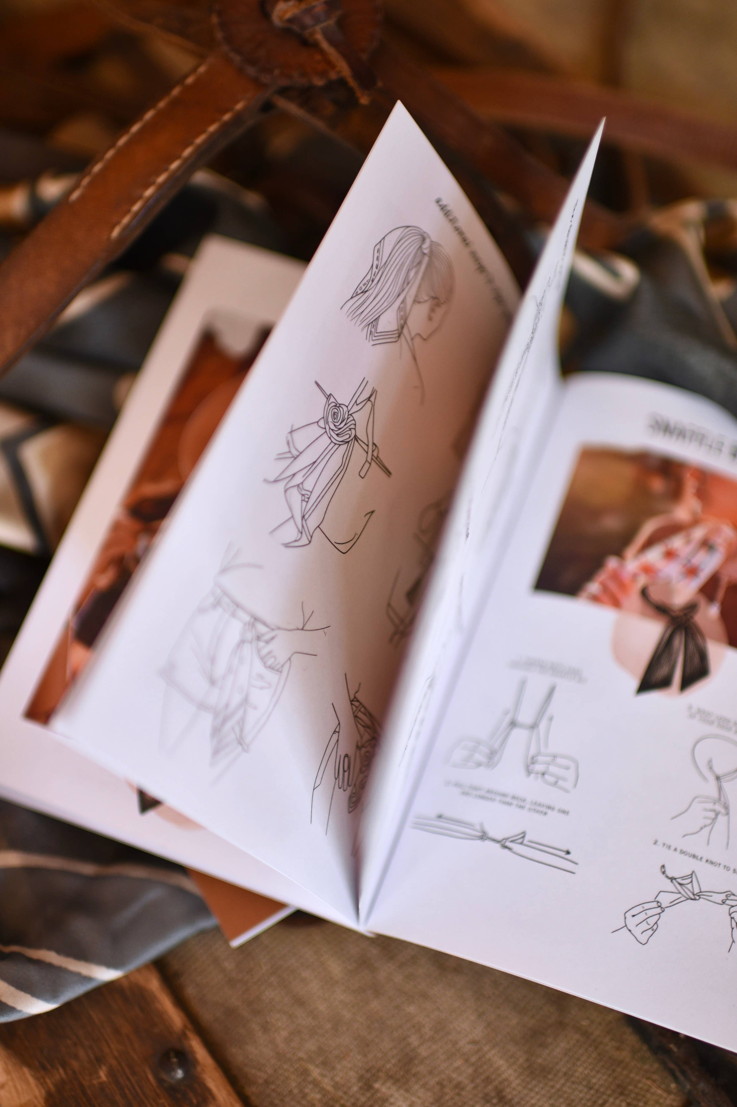 Open book with illustrations on a wooden surface