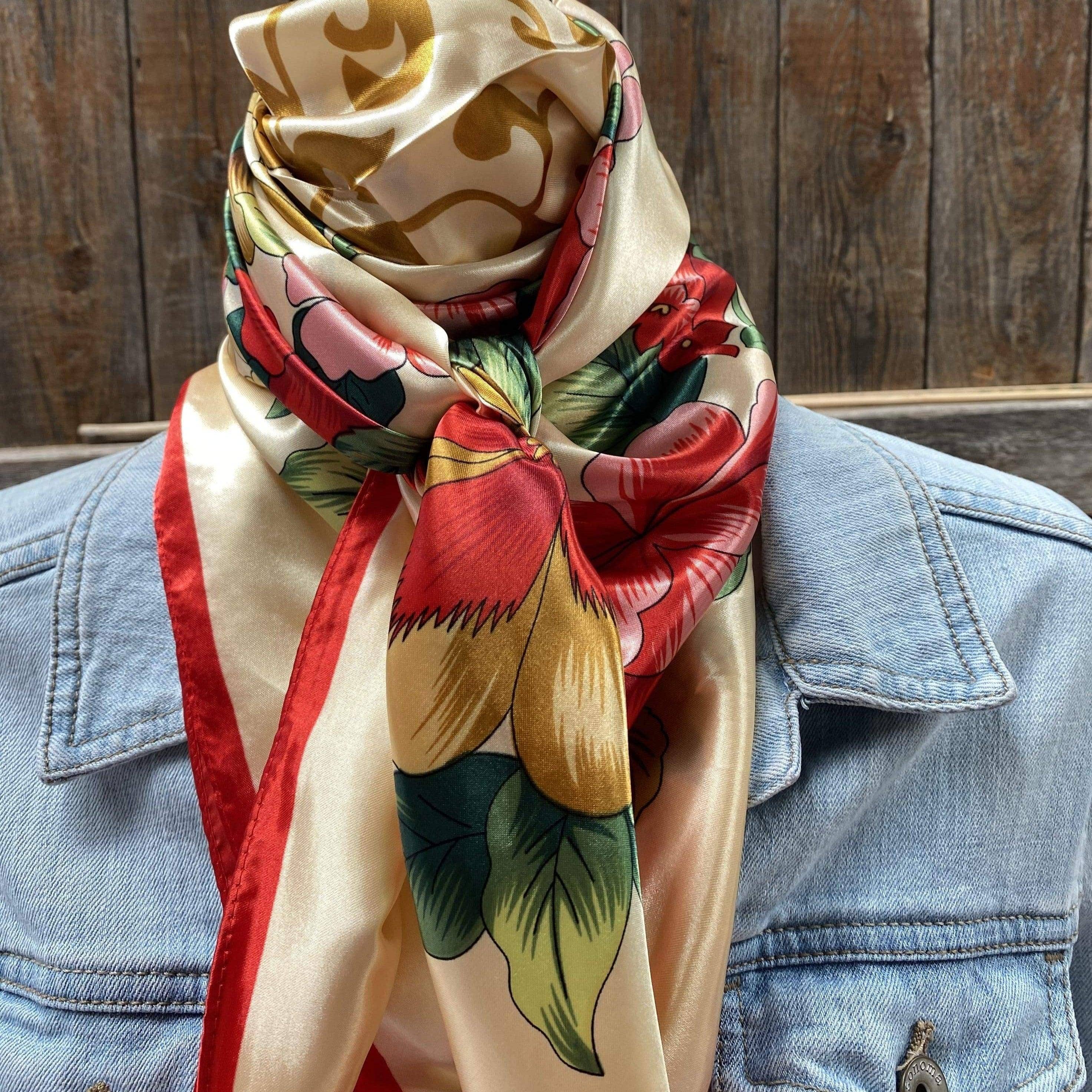Person wearing a colorful floral scarf with a wooden background