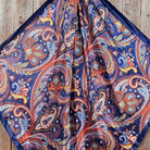 Close-up of a colorful paisley patterned scarf on a wooden surface