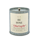 Candle with 'Be Mine' label on a white background