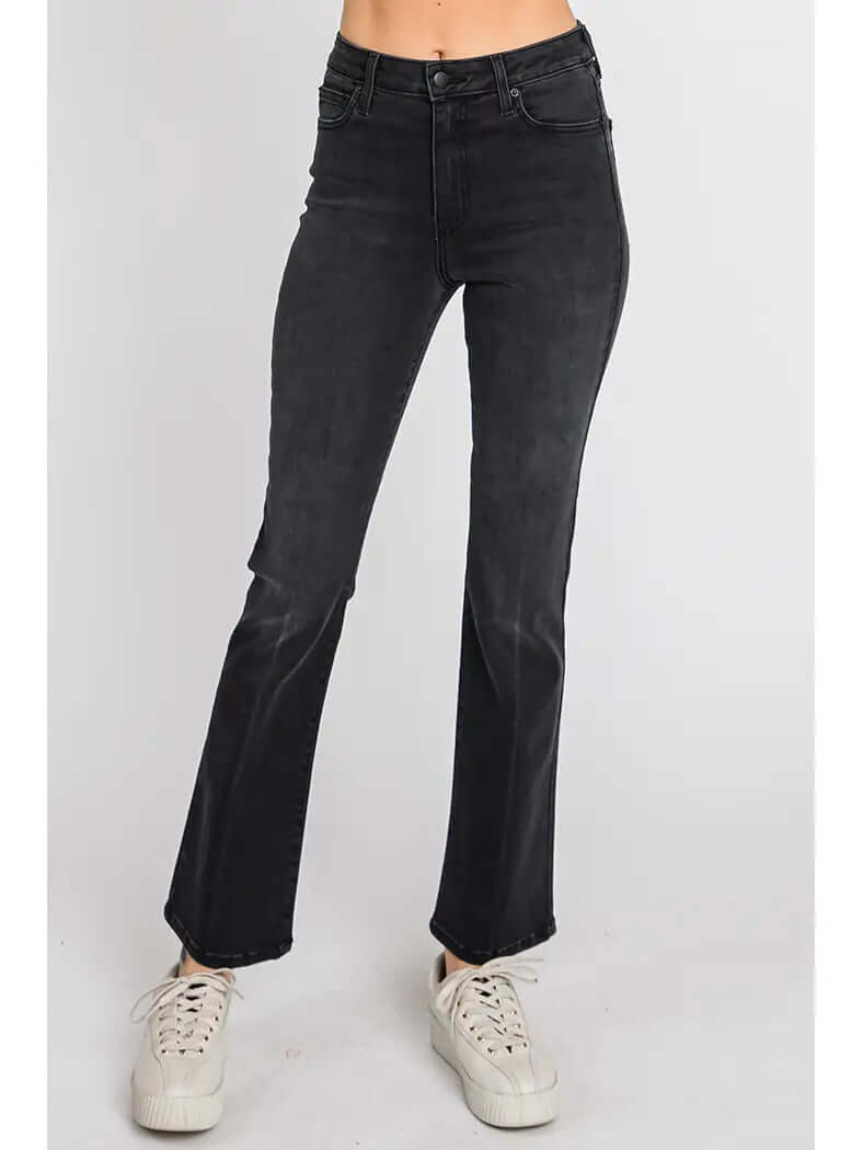 Black jeans worn by a person on a white background