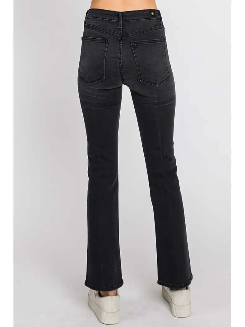 Black jeans worn by a person on a white background